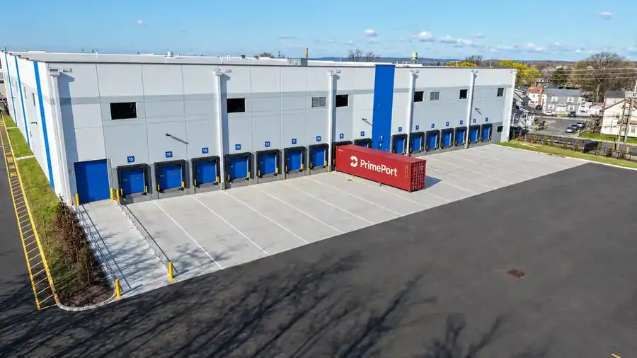 Fifteen loading dock doors at the PrimePort facility with containers staged in the yard
